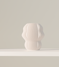 Marea table lamp with a fluid wave-like form and warm glow, 3D printed in Australia
