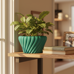 Teal-green Solis planter with a leafy plant on a wooden shelf in a cozy home office, styled with books and a framed photo