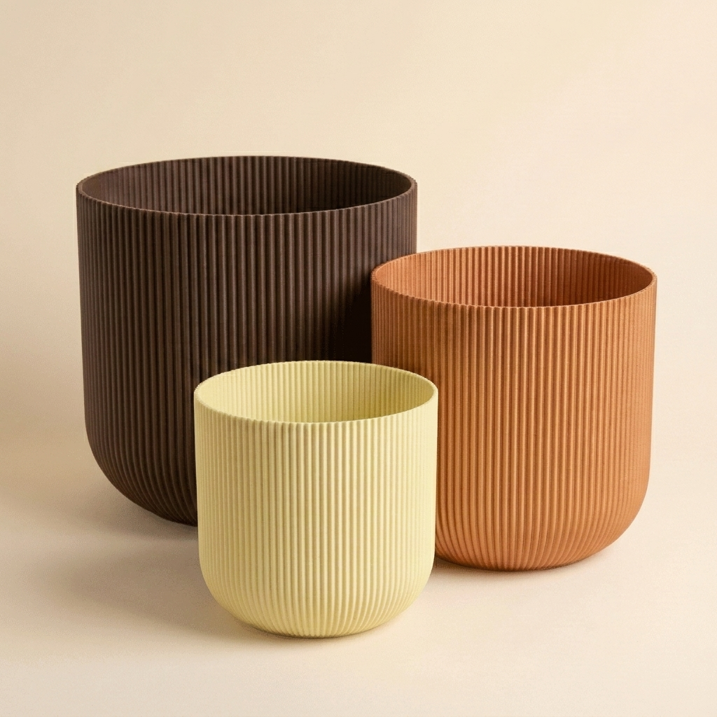The Forma Trio nesting planter set in Warm Clay — almond yellow, copper and chocolate gradient